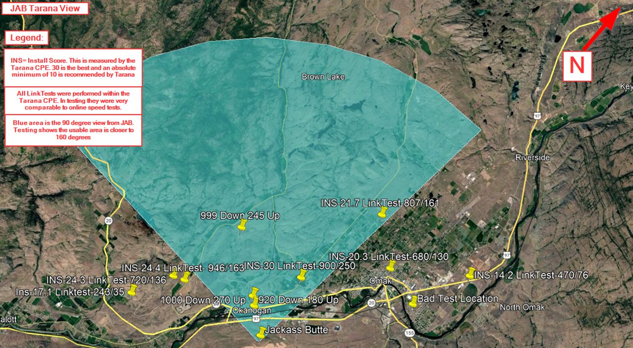 The District's Jackass Butte coverage test map: a shaded sector over the Okanogan valley with yellow field-test pins showing install scores and download/upload speeds at Omak and North Omak
